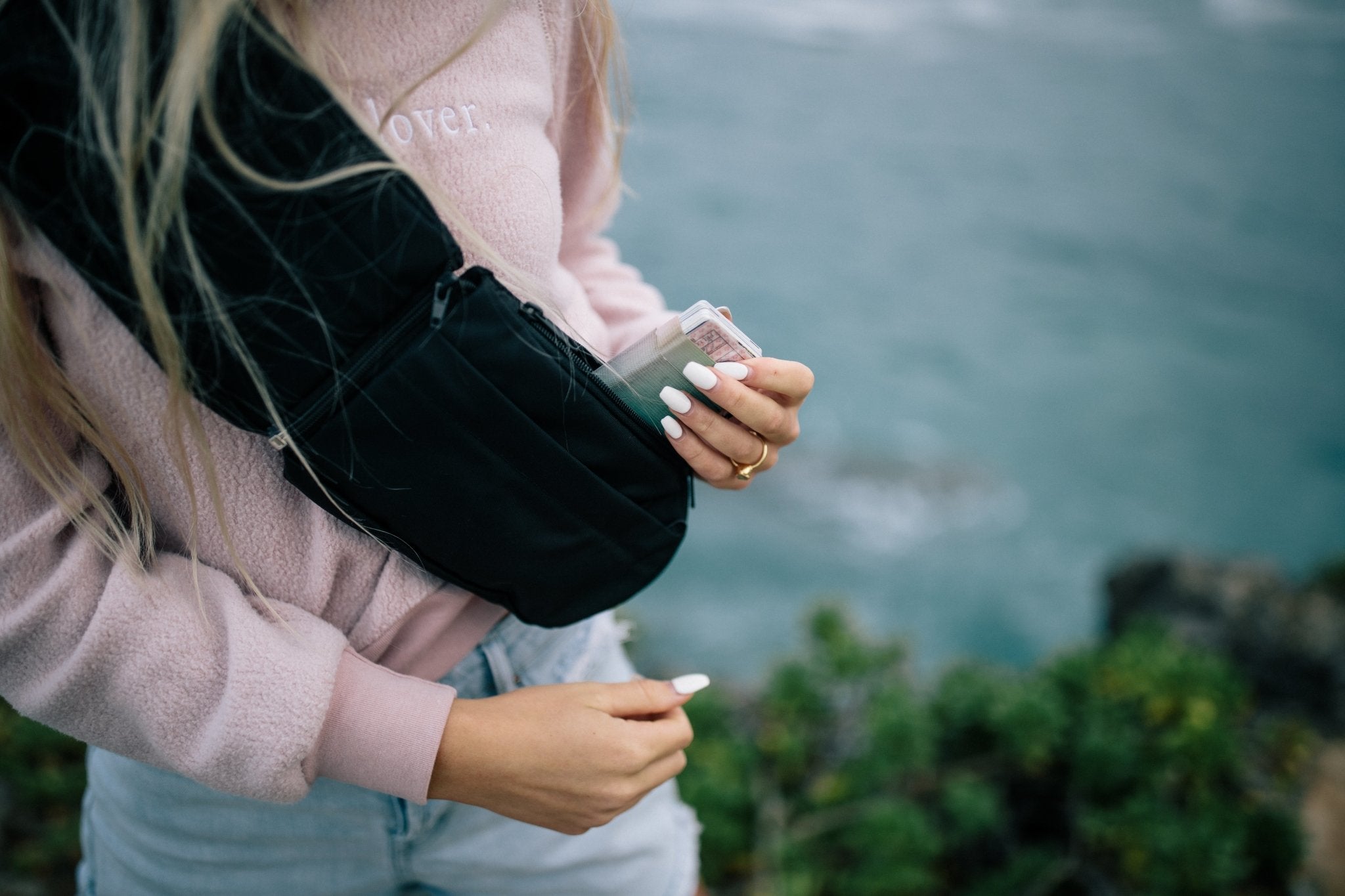 2L Sling Belt (42L Backpack Waist Belt/Sling Bag) - Gravel - Woman holding wallet going inside of 2 Liter Sling Bag