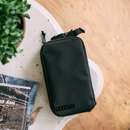 Garage Sale | V1 Explorer SLIM™ Toiletry Bag - Traveling Lighter - Gravel - The Explorer SLIM™ Toiletry Bag closed on a table.