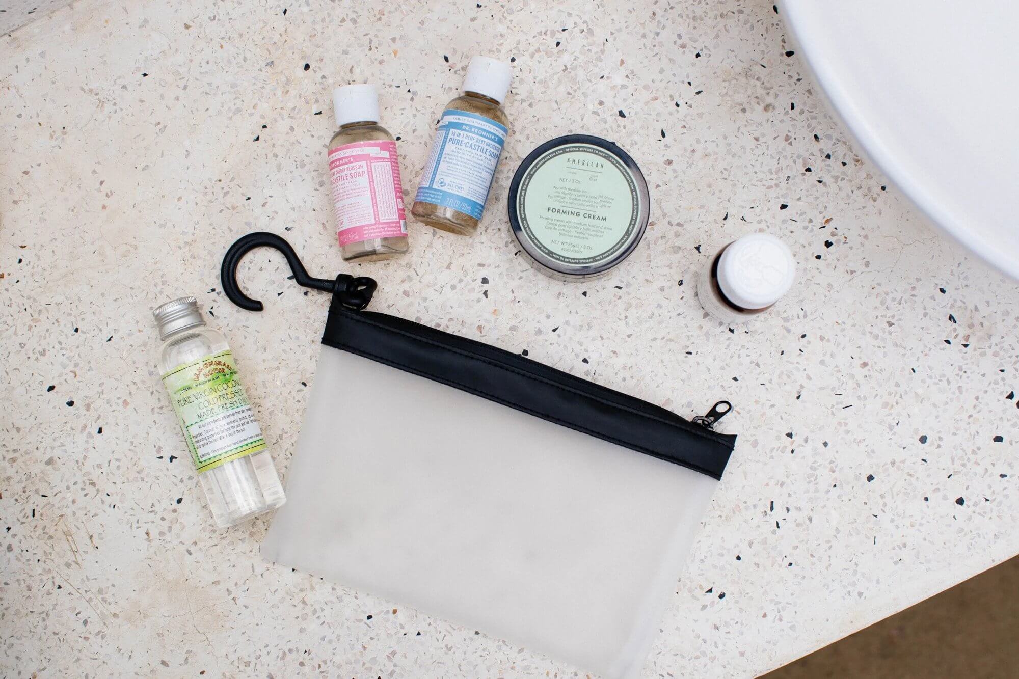 toiletries and zip pouch on terrazzo countertop