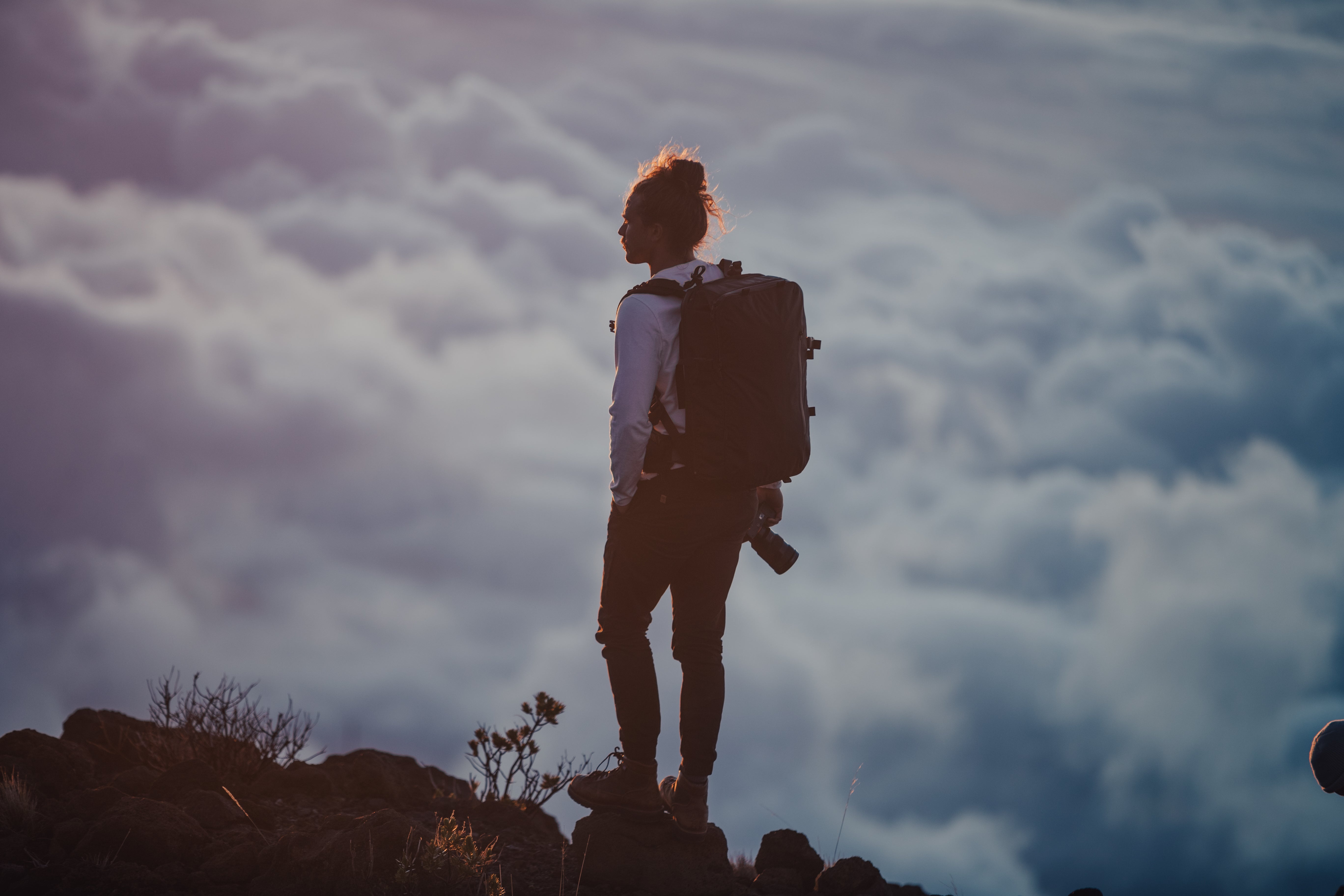 packing light backpacker above clouds