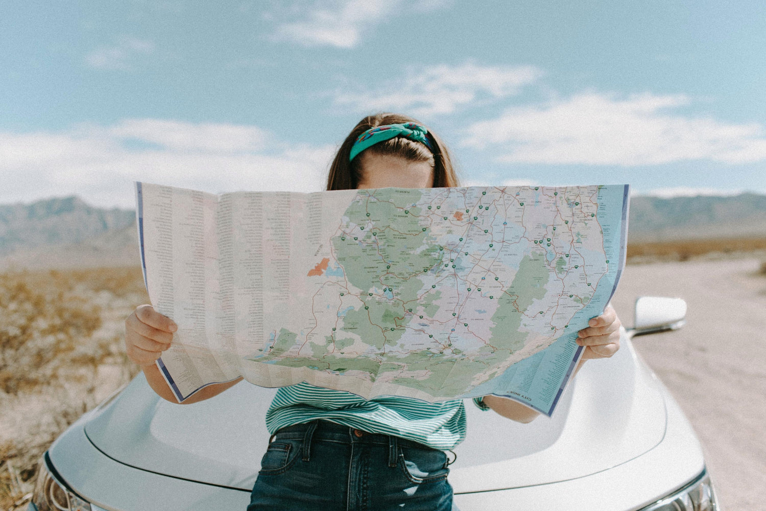 road trip essentials person holding map
