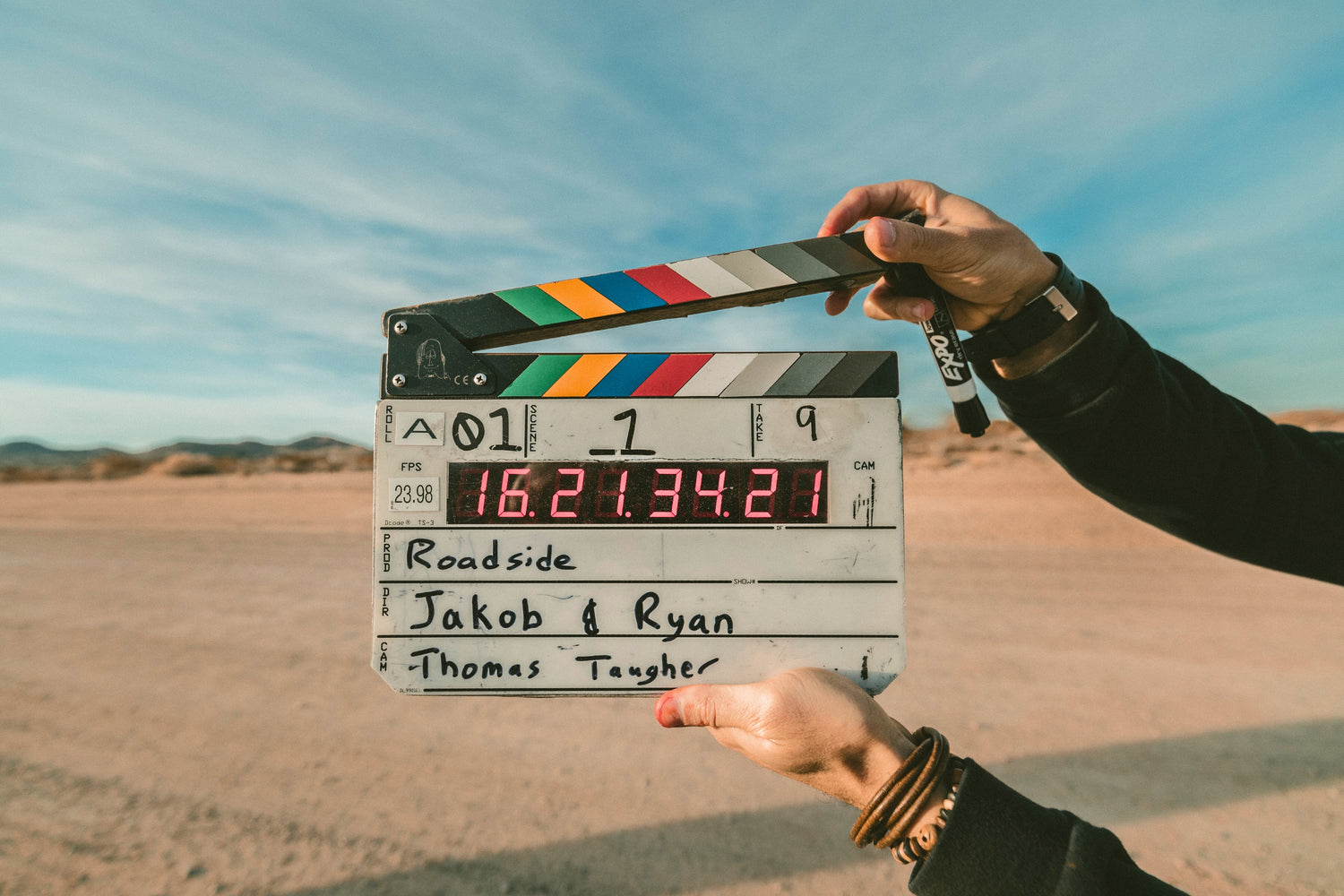 set jetting hands holding clapperboard
