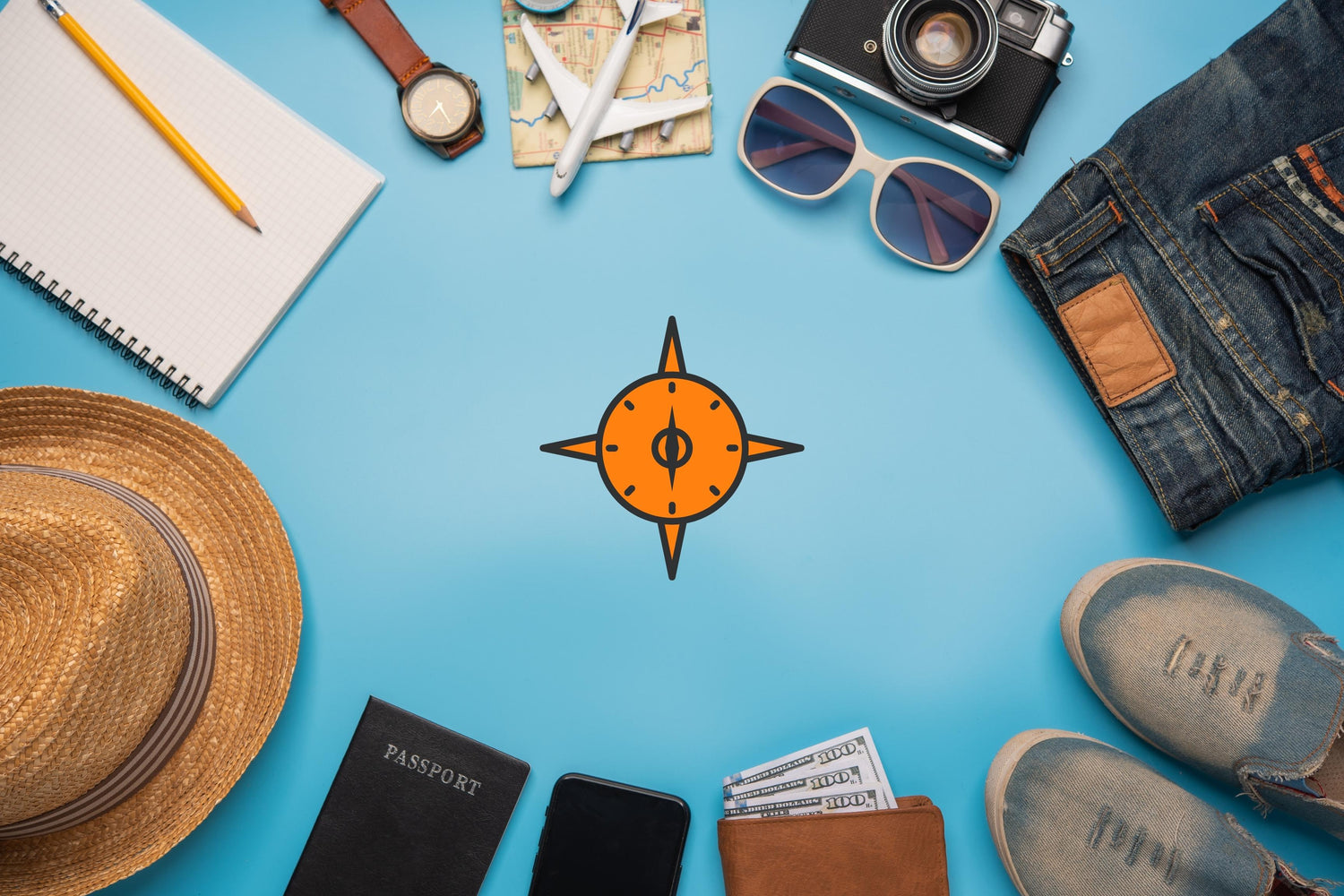 travel accessories flat lay orange compass