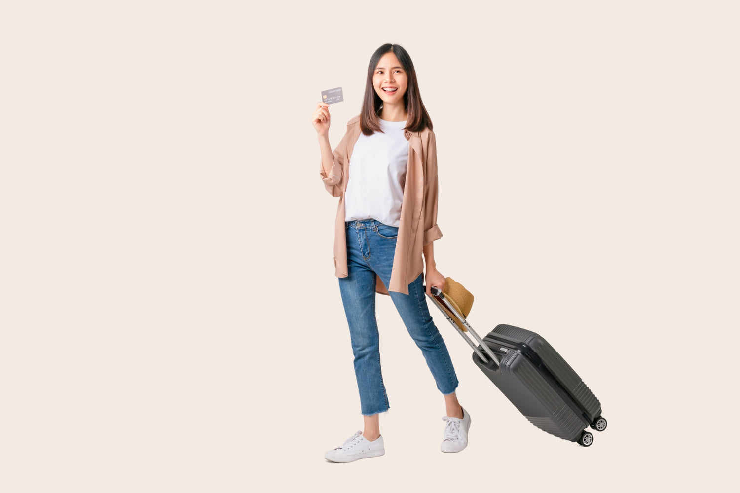 traveler with carry-on holding credit card