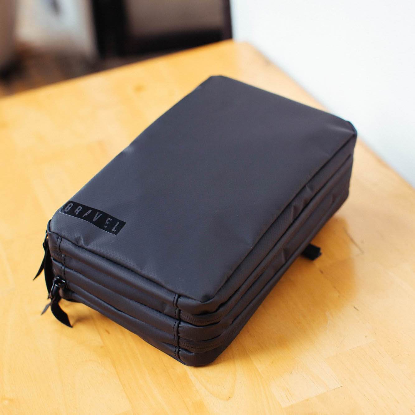 Garage Sale | Explorer PLUS™ Toiletry Bag - Packing More - Gravel - The Explorer plus closed on a table